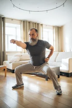 an elderly man warming up for his exercise routine